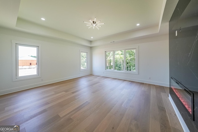972 Auburn Rd, Dacula, GA 30019 - unfurnished living room with a raised ceiling, wood finished floors, baseboards, and recessed lighting