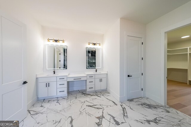 972 Auburn Rd, Dacula, GA 30019 - bathroom featuring vanity, baseboards, marble look tile flooring, and a spacious closet