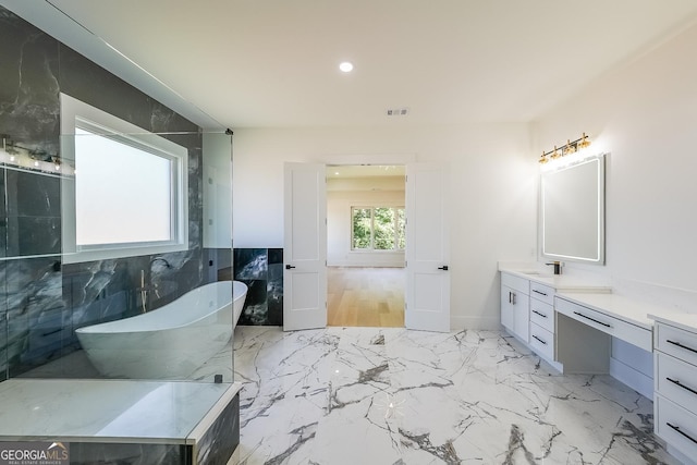 972 Auburn Rd, Dacula, GA 30019 - bathroom with a freestanding bath, vanity, recessed lighting, and marble finish flooring