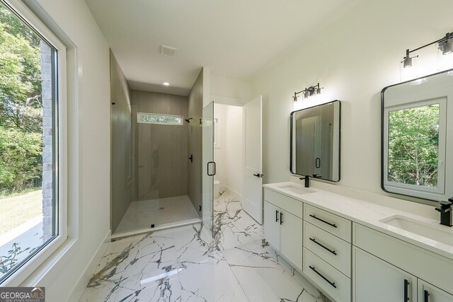 972 Auburn Rd, Dacula, GA 30019 - full bathroom featuring a shower stall, double vanity, marble look tile flooring, recessed lighting, and baseboards