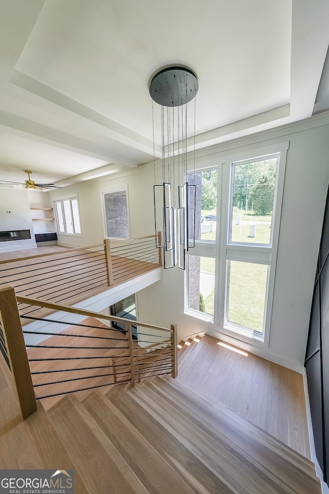 972 Auburn Rd, Dacula, GA 30019 - stairs featuring a ceiling fan, wood finished floors, and a tray ceiling
