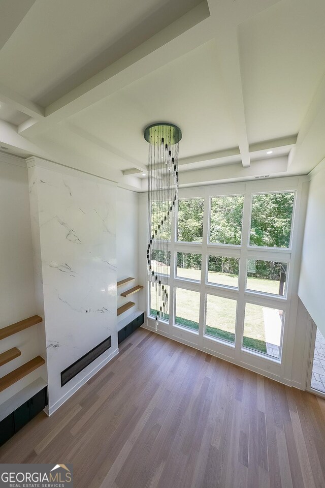 972 Auburn Rd, Dacula, GA 30019 - unfurnished dining area with beam ceiling, wood finished floors, and a fireplace