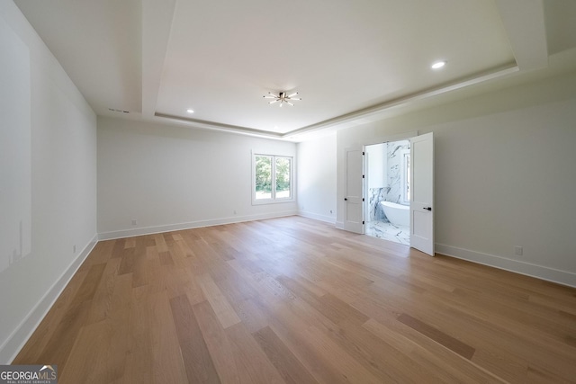 972 Auburn Rd, Dacula, GA 30019 - empty room with a chandelier, a raised ceiling, light wood finished floors, baseboards, and recessed lighting