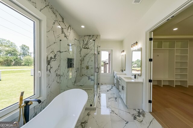 972 Auburn Rd, Dacula, GA 30019 - bathroom with a marble finish shower, double vanity, a freestanding bath, recessed lighting, and a walk in closet