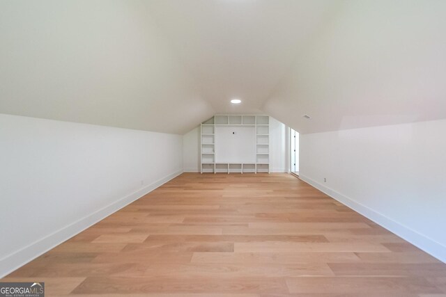 972 Auburn Rd, Dacula, GA 30019 - additional living space featuring baseboards, built in features, vaulted ceiling, and light wood-type flooring