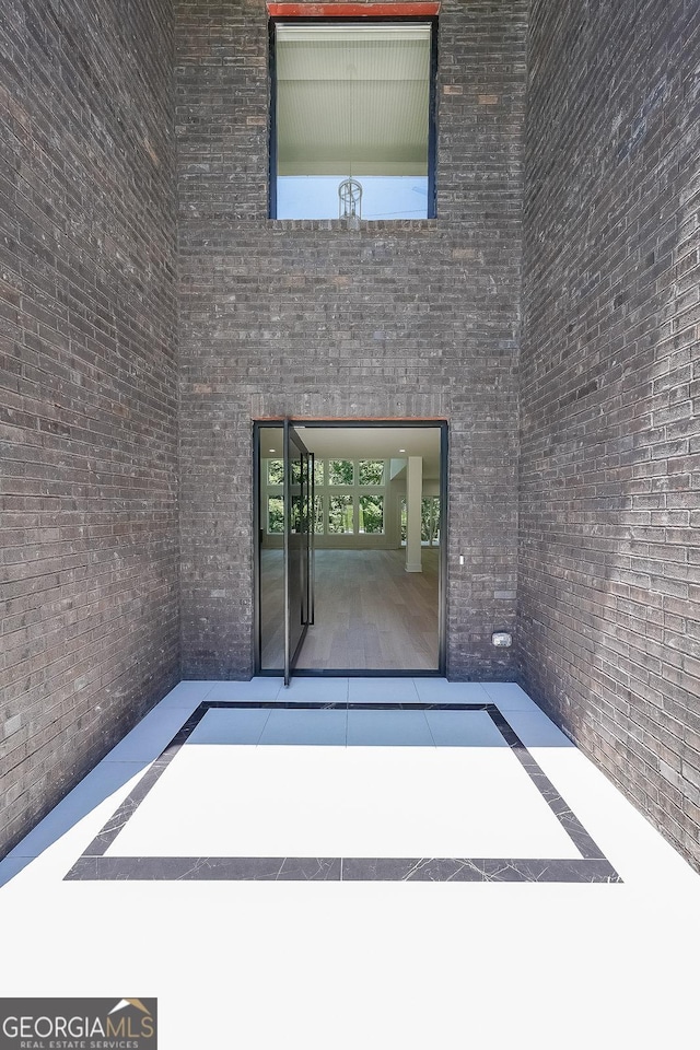 972 Auburn Rd, Dacula, GA 30019 - view of exterior entry featuring a patio and brick siding