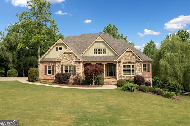 craftsman-style house with a front yard, stone siding, and board and batten siding