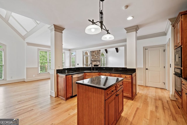 kitchen with ornate columns, dishwasher, a sink, black oven, and ornamental molding