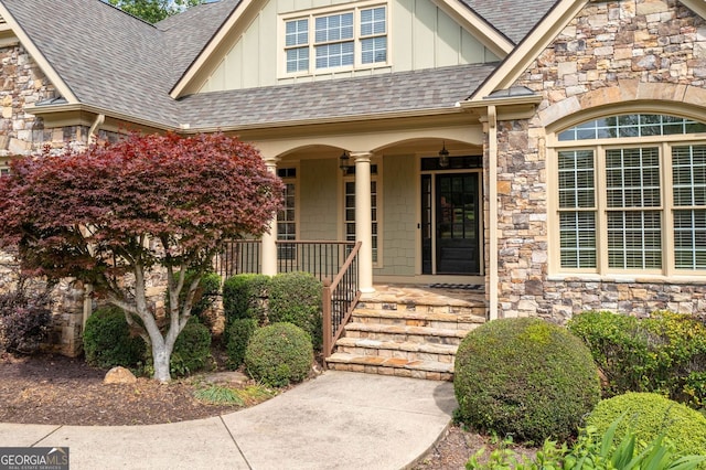 property entrance featuring board and batten siding, a porch, and a shingled roof