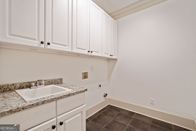 clothes washing area featuring hookup for a washing machine, cabinet space, hookup for an electric dryer, baseboards, and dark tile patterned flooring