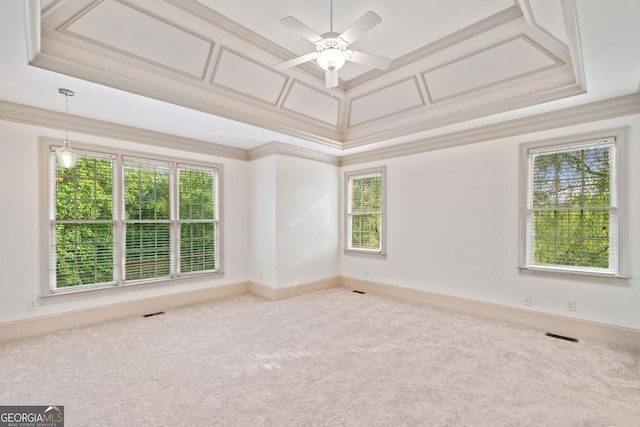 empty room with crown molding, plenty of natural light, carpet floors, and ceiling fan