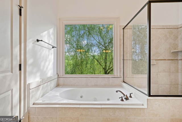 bathroom with a tub with jets