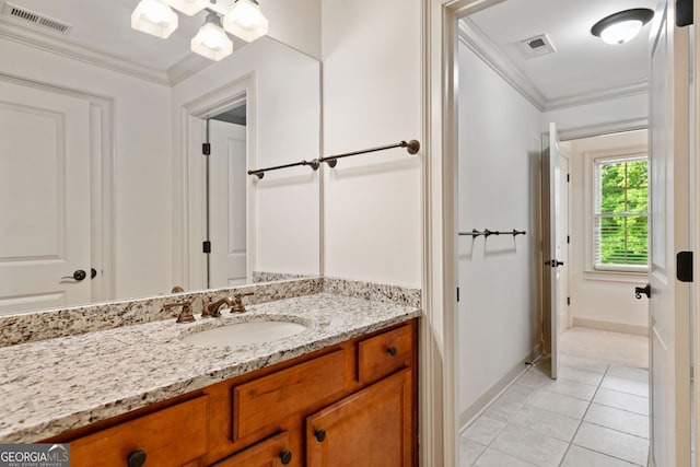 bathroom with vanity, baseboards, tile patterned floors, and crown molding