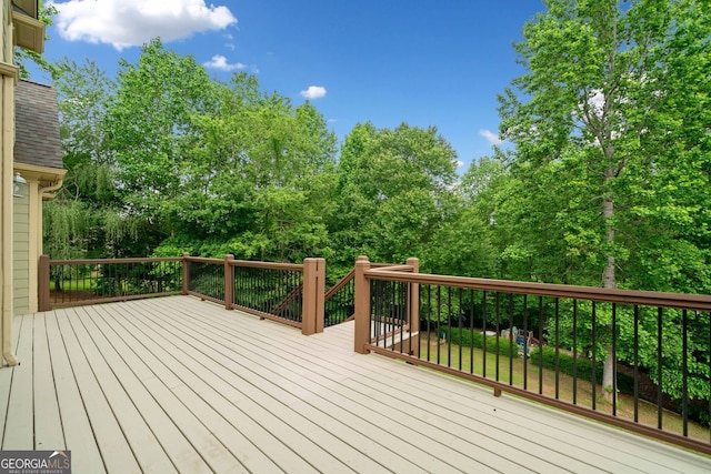 deck featuring view of scattered trees