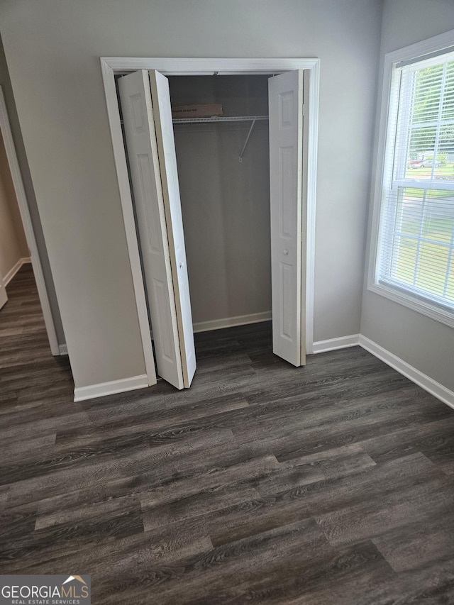 414 E 17th St SW, Rome, GA 30161 - unfurnished bedroom featuring dark wood-style flooring, a closet, and baseboards