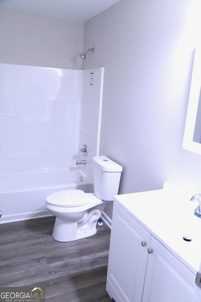 414 E 17th St SW, Rome, GA 30161 - bathroom with vanity, toilet, bathing tub / shower combination, and wood finished floors