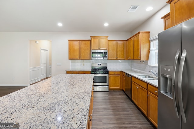 131 Prominence Ct, Canton, GA 30114 - kitchen with appliances with stainless steel finishes, backsplash, dark wood finished floors, a sink, and recessed lighting