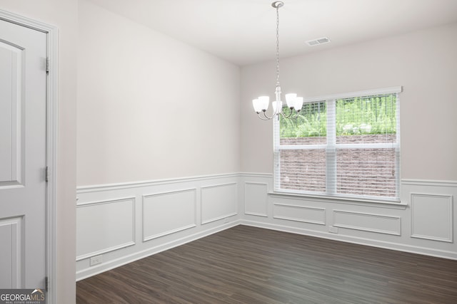131 Prominence Ct, Canton, GA 30114 - unfurnished dining area featuring a chandelier, wainscoting, dark wood-style floors, and a decorative wall