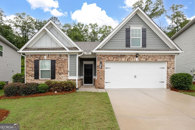 131 Prominence Ct, Canton, GA 30114 - craftsman house featuring brick siding, concrete driveway, a front lawn, board and batten siding, and a garage