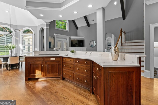 3905 Merriweather Woods, Johns Creek, GA 30022 - kitchen featuring open floor plan, light wood finished floors, light stone counters, recessed lighting, and arched walkways