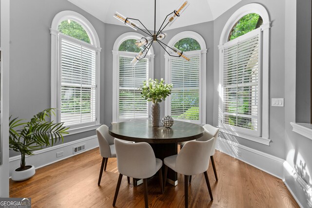 3905 Merriweather Woods, Johns Creek, GA 30022 - dining room with a chandelier, wood finished floors, lofted ceiling, and baseboards