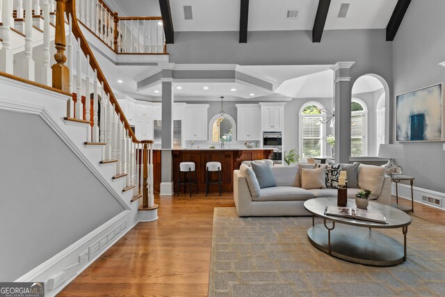 3905 Merriweather Woods, Johns Creek, GA 30022 - living area with a towering ceiling, light wood-style floors, beamed ceiling, recessed lighting, and stairway