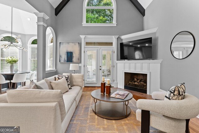 3905 Merriweather Woods, Johns Creek, GA 30022 - living room with high vaulted ceiling, wood finished floors, a chandelier, and a fireplace