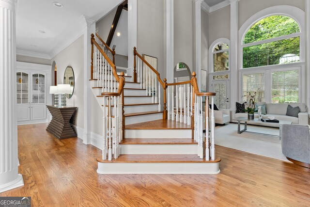 3905 Merriweather Woods, Johns Creek, GA 30022 - staircase featuring healthy amount of natural light, wood finished floors, ornamental molding, recessed lighting, and a high ceiling