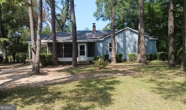 203 S Valencia Dr, Albany, GA 31707 - ranch-style home with entry steps, a front lawn, a sunroom, and a chimney