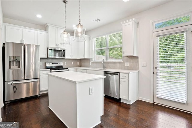 kitchen featuring appliances with stainless steel finishes, white cabinets, light countertops, recessed lighting, and dark wood-style flooring