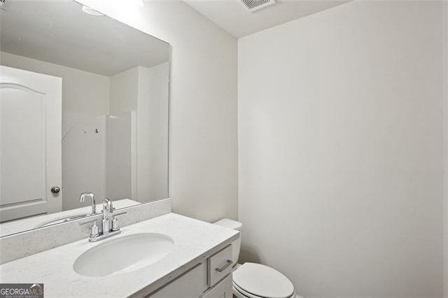 bathroom featuring toilet and vanity