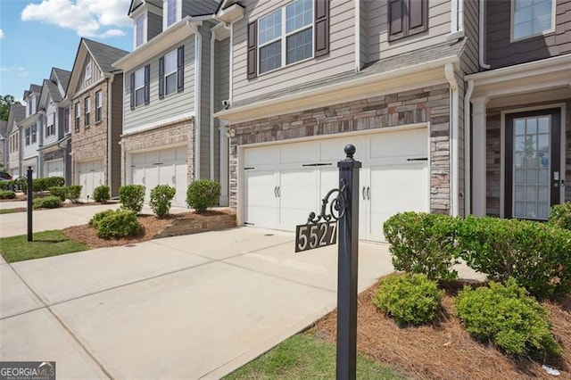 view of side of home with a garage, driveway, and a residential view