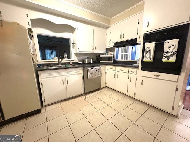 123 Hillview Dr, Thomaston, GA 30286 - kitchen featuring appliances with stainless steel finishes, dark countertops, ornamental molding, a textured ceiling, and a sink