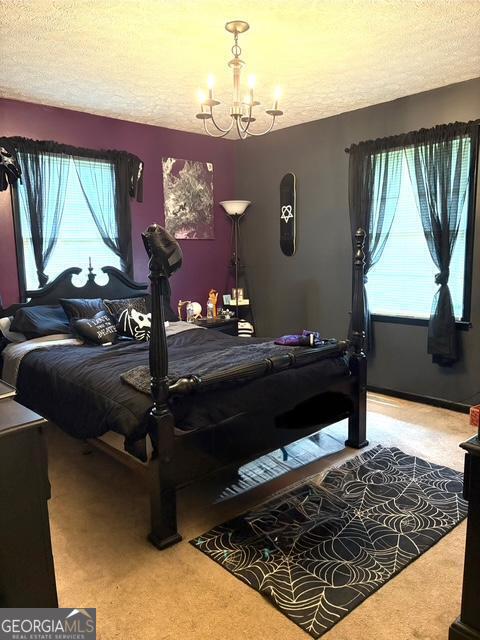 123 Hillview Dr, Thomaston, GA 30286 - carpeted bedroom with a chandelier and a textured ceiling