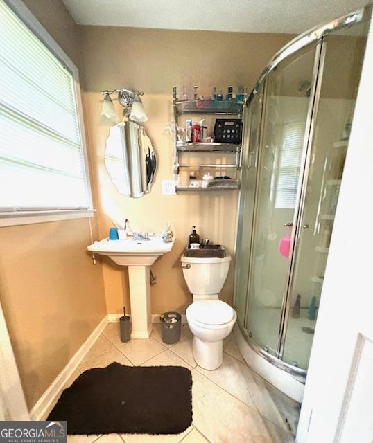 123 Hillview Dr, Thomaston, GA 30286 - bathroom featuring tile patterned flooring, a stall shower, and toilet