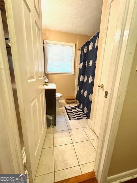 123 Hillview Dr, Thomaston, GA 30286 - full bath with tile patterned floors, a textured ceiling, vanity, toilet, and a shower with shower curtain