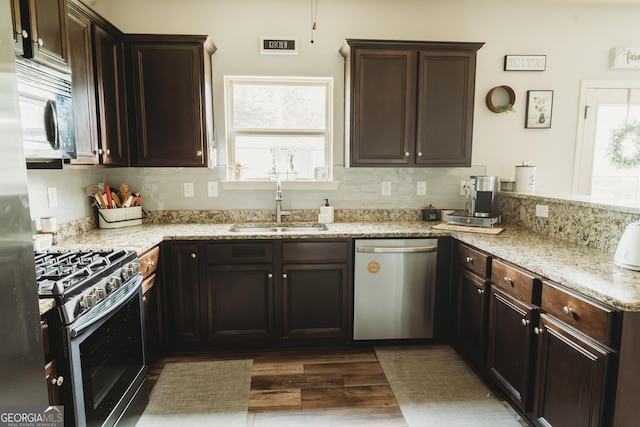 258 Creek View Ln, Acworth, GA 30102 - kitchen with appliances with stainless steel finishes, a sink, dark wood-style flooring, decorative backsplash, and healthy amount of natural light