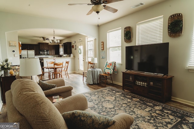 258 Creek View Ln, Acworth, GA 30102 - living room with arched walkways, a ceiling fan, light wood-type flooring, and baseboards