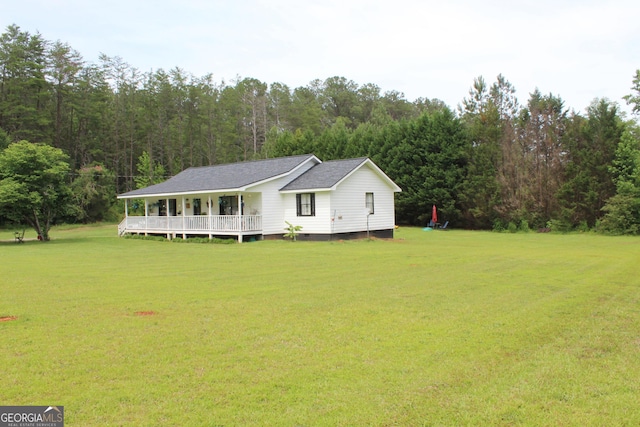 124 Wynn Rd, Mcdonough, GA 30252 - view of front of house with a front yard, a forest view, crawl space, and a shingled roof
