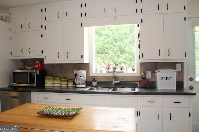 124 Wynn Rd, Mcdonough, GA 30252 - kitchen featuring stainless steel appliances, a sink, white cabinetry, and tasteful backsplash