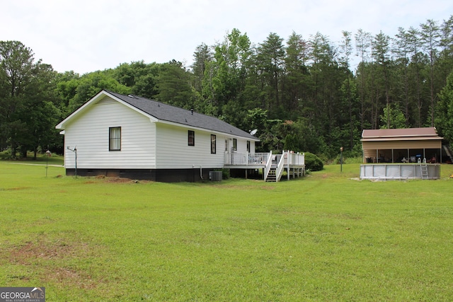 124 Wynn Rd, Mcdonough, GA 30252 - view of green lawn featuring a deck, a view of trees, and cooling unit