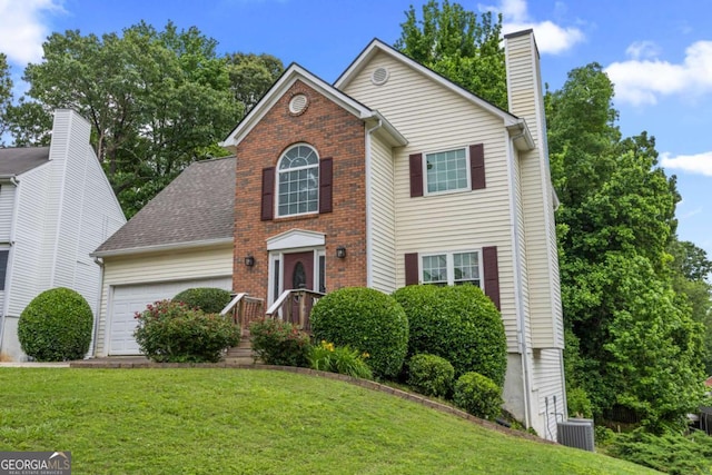 view of front of property with an attached garage, a front yard, a chimney, central AC unit, and brick siding