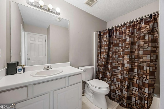 bathroom with toilet, vanity, tile patterned floors, curtained shower, and a textured ceiling