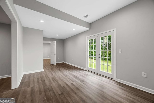unfurnished living room featuring baseboards, wood finished floors, recessed lighting, and french doors