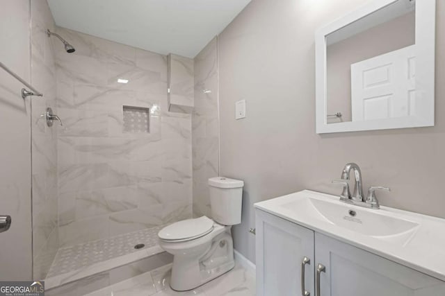 full bath with marble finish floors, a tile shower, toilet, and vanity