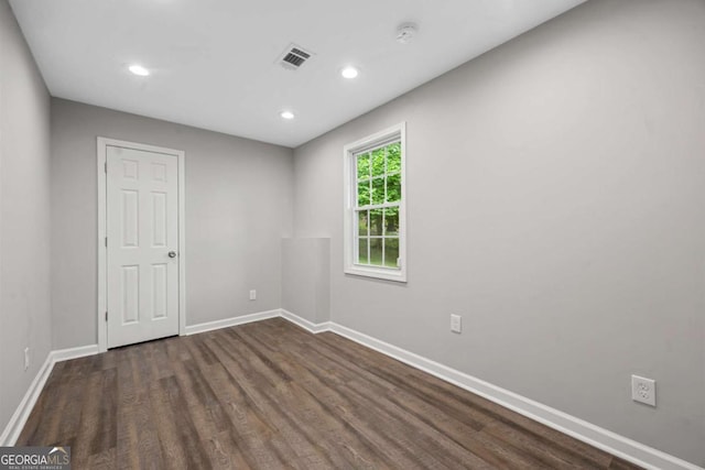 unfurnished room featuring wood finished floors, baseboards, recessed lighting, and a smoke detector
