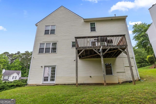 back of property with a deck, a yard, and french doors