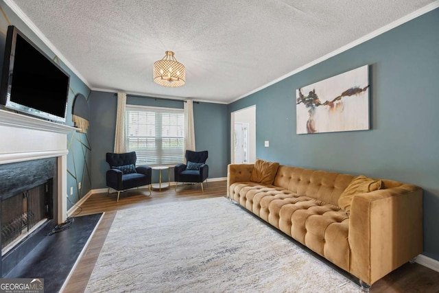 4305 Chesapeake Trce, Acworth, GA 30101 - living area featuring ornamental molding, wood finished floors, a textured ceiling, and a fireplace with flush hearth