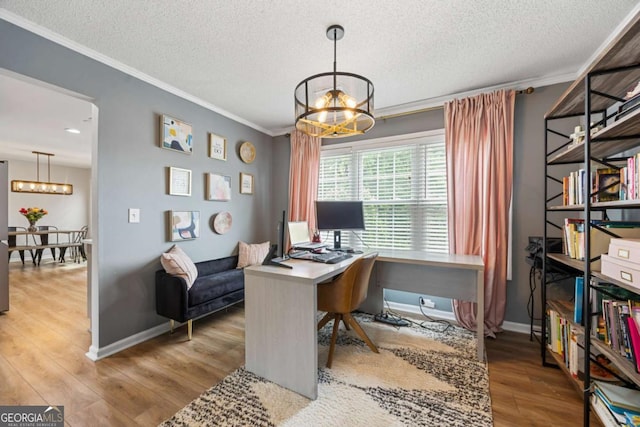 4305 Chesapeake Trce, Acworth, GA 30101 - home office featuring a chandelier, ornamental molding, a textured ceiling, and wood finished floors
