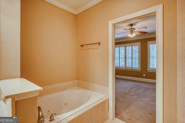 bathroom featuring crown molding, a tub with jets, a ceiling fan, and baseboards